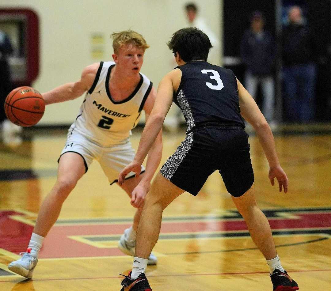 Mountainside's Brayden Boe (2) works against the defense of Tualatin's Ryan Schleicher (3) on Friday. (Photo by Jon Olson)