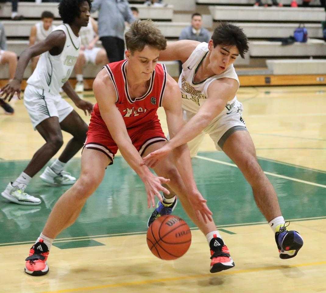 Lincoln's Moroni Seely-Roberts (left) battles against the defense of Jesuit's Payton Roth on Tuesday. (Photo by Norm Maves Jr.)