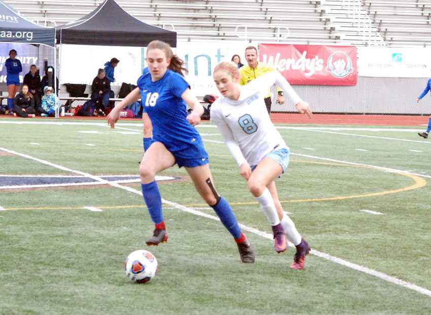 Sophia Spry (18) of Catlin Gabel and Stephanie Filnley of OES work for possession in the OSAA 3A/2A/1A soccer final on Saturday