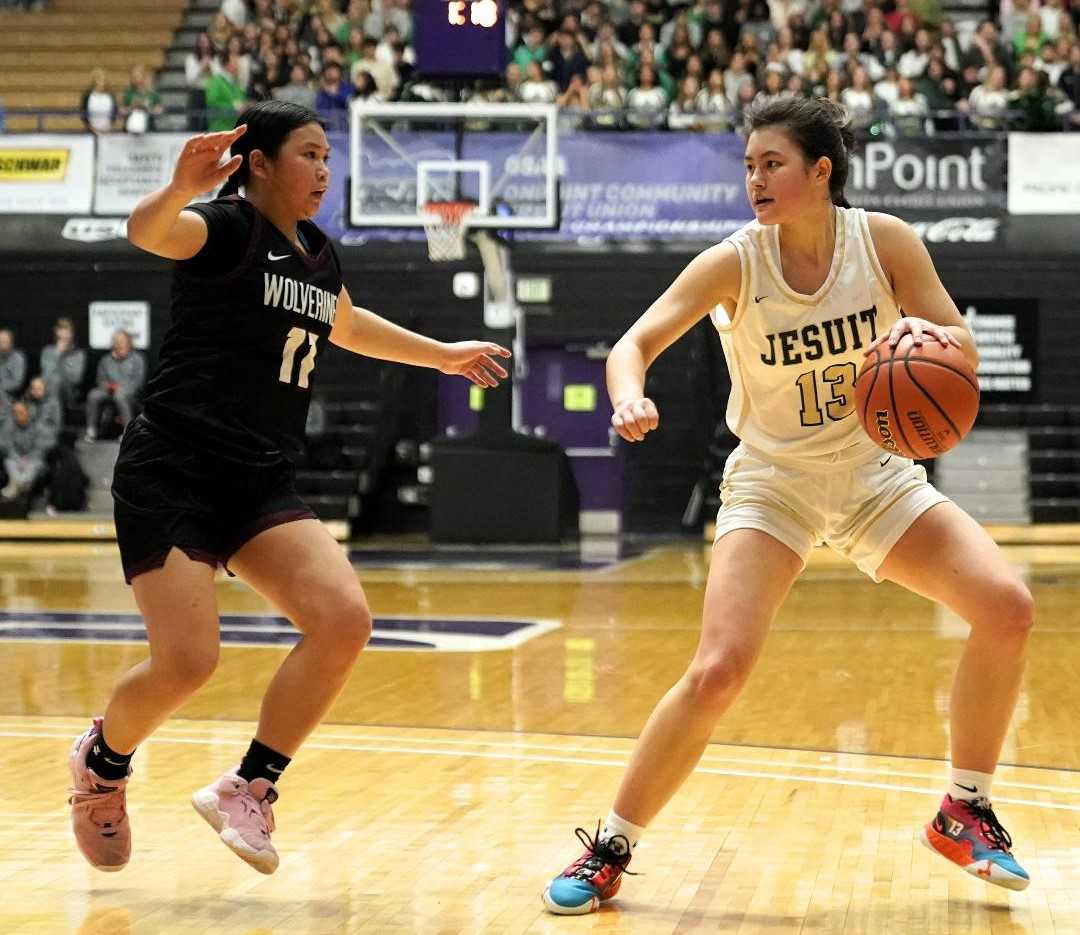 Jesuit's Emma Sixta (13) works against the defense of Willamette's Victoria Nguyen (11) on Wednesday. (Photo by Jon Olson)