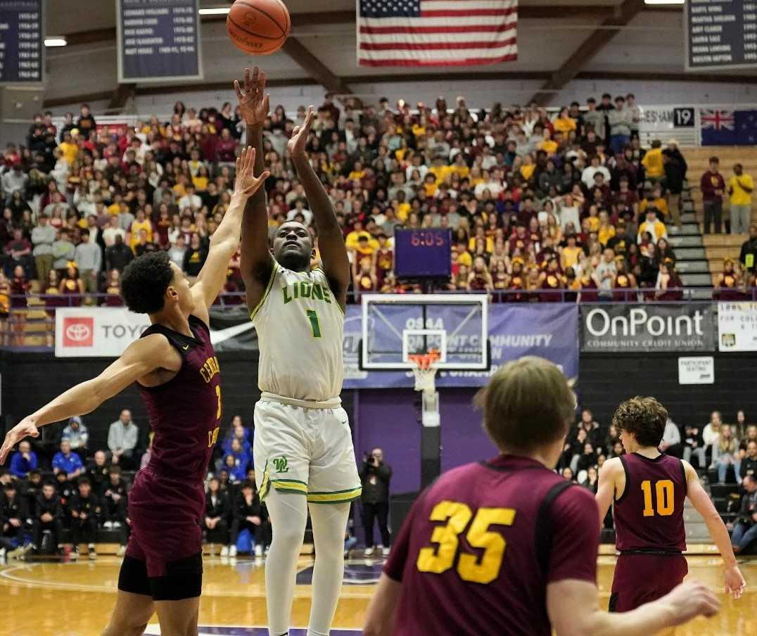 Senior guard Adrian Mosley (1) scored 21 points for West Linn, coming up big in the fourth quarter. (Photo by Jon Olson)