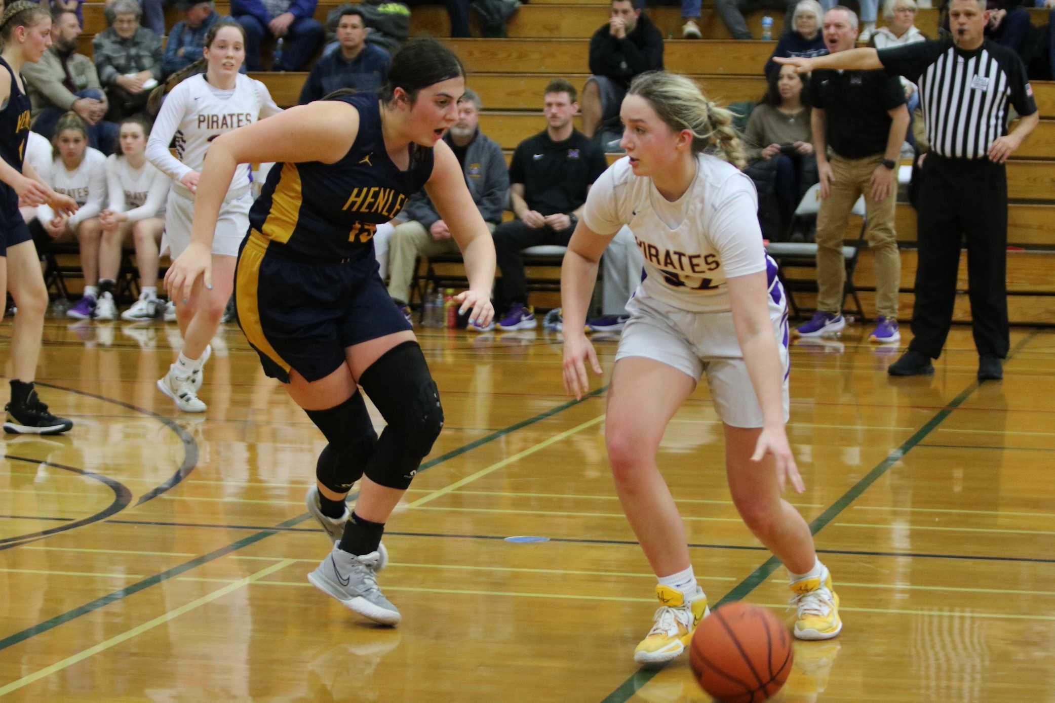 Marshfield's Kate Miles (right) draws pressure from Henley's Annie Campos in Thursday's quarterfinals. (Photo by Jim Beseda)