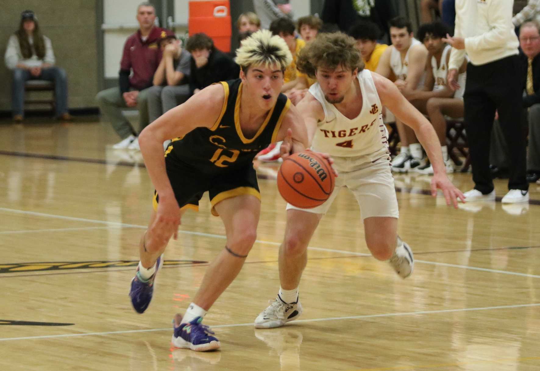 Cascade's Spencer Horne (left) keeps the ball away from Junction City's Gunner Rothenberger in Friday's semifinal. (Jim Beseda)