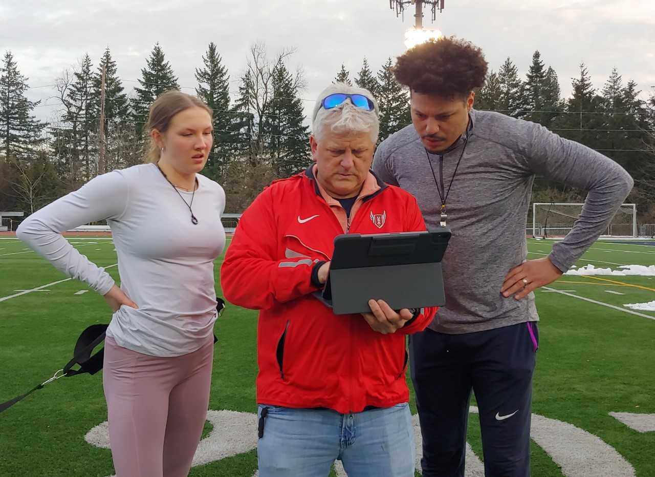 Mia Brahe-Pedersen trains with new head coach John Parks (center) and assistant Ryan Bailey (right). (Doug Binder/DyeStat)