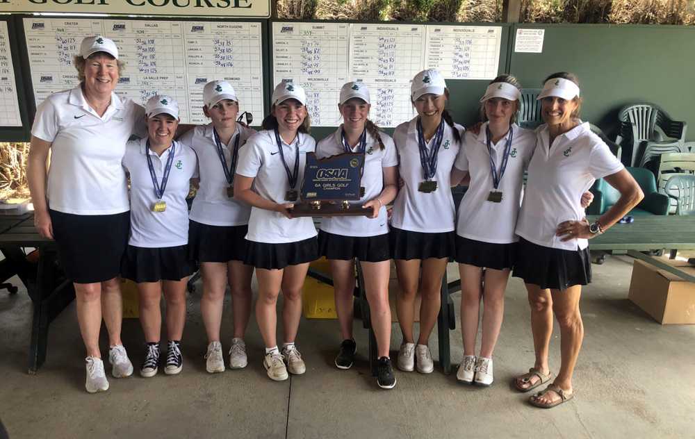 Flanked by coaches Laurie Wagner (left) and Michelle Gray, Jesuit's six-player roster poses, once again, with the hardware