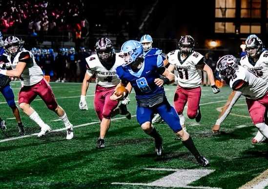 Liberty quarterback Reid Linkmeyer is boxed in by Sherwood's defense Friday night. (Photo by Fanta Mithmeuangneua)