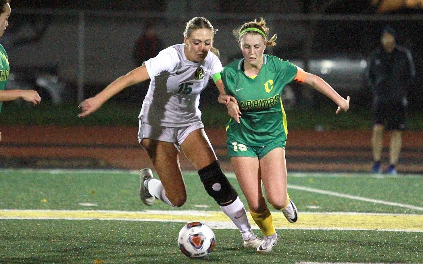 Cleveland's Elsie Koehler (right) battles West Linn's Kate Cheldelin for possession Tuesday. (Miles Vance Sports Journal)