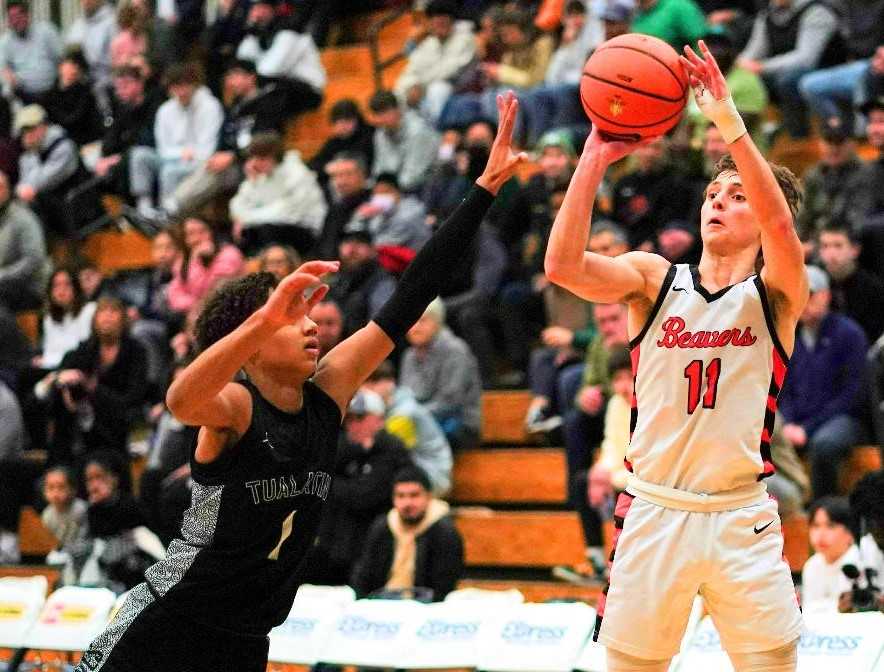 Beaverton's Aidan Rice, shooting over Tualatin's Jemai Lake, made five three-pointers and scored 26 points. (Photo by Jon Olson)