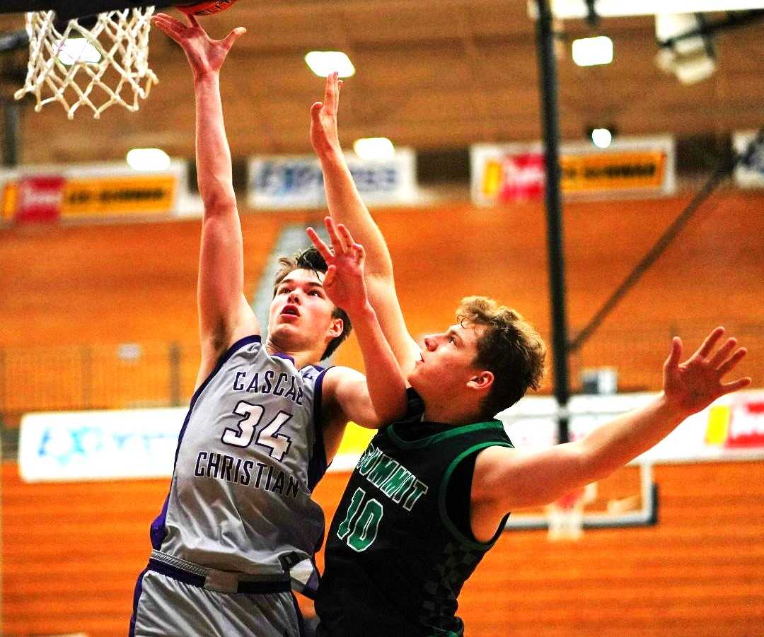 Cascade Christian's Austin Maurer (34) shoots over Summit's Charlie Crowell at the LSI. (Photo by Jon Olson)