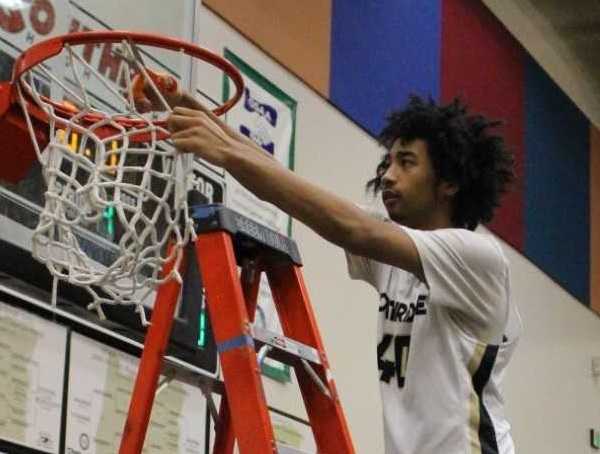 Southridge's Brock Henry cuts down the net after the Skyhawks won the Metro League title last season.