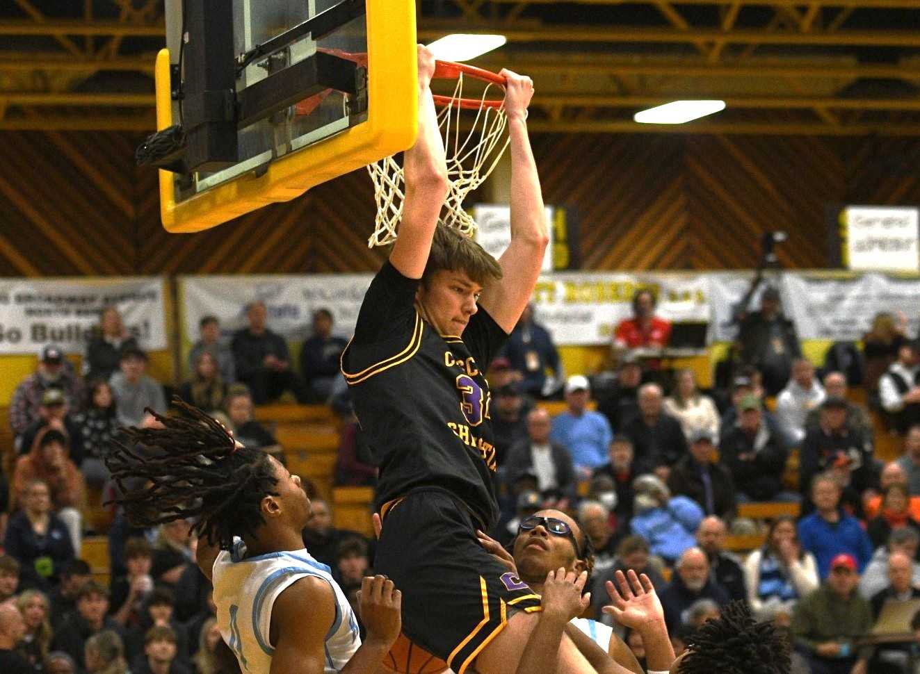 Cascade Christian's Austin Maurer throws down a reverse dunk Thursday for two of his 24 points. (Photo by John Gunther)