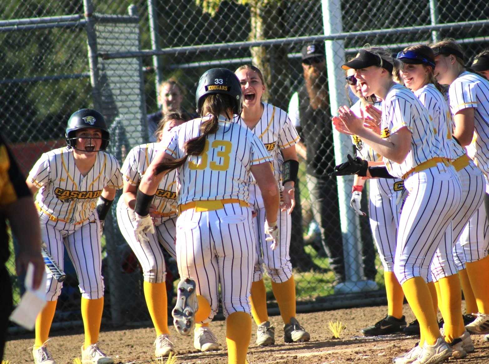 Cascade's Amyah Miranda is greeted at home plate after hitting a solo homer against Stayton. (Photo by Jeremy McDonald)