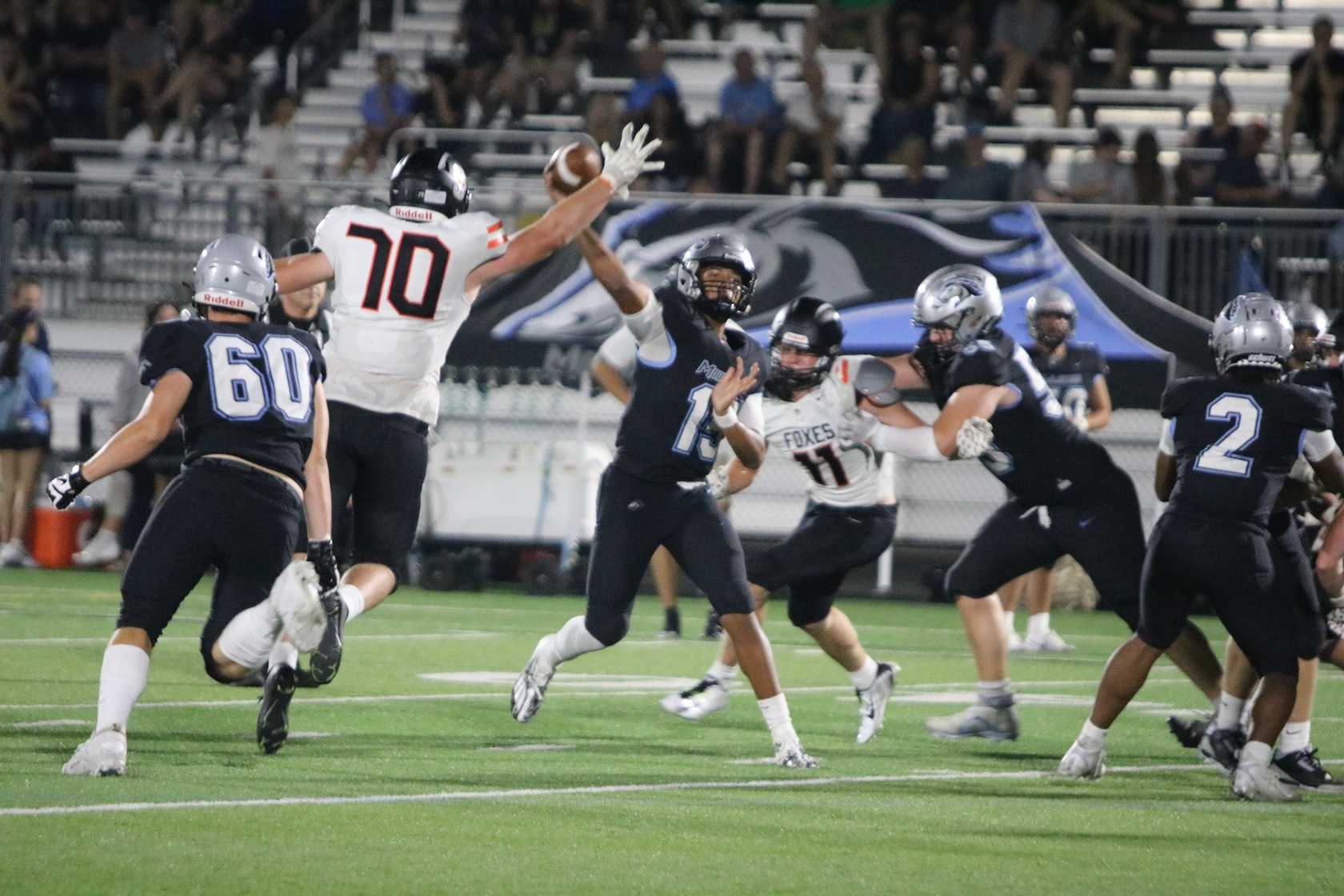 Silverton's Eli Willis (70) and Brody Kuenzi (11) pressure Mountainside quarterback Cade Mitchell on Friday. (Jim Beseda photo)