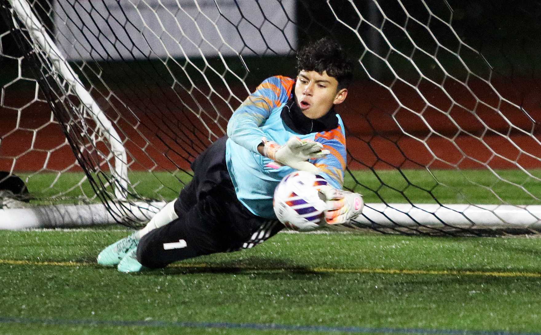 Henley sophomore goalkeeper Carlos Ivan Garcia makes one of his four penalty-kick shootout saves. (Photo by Dan Brood).