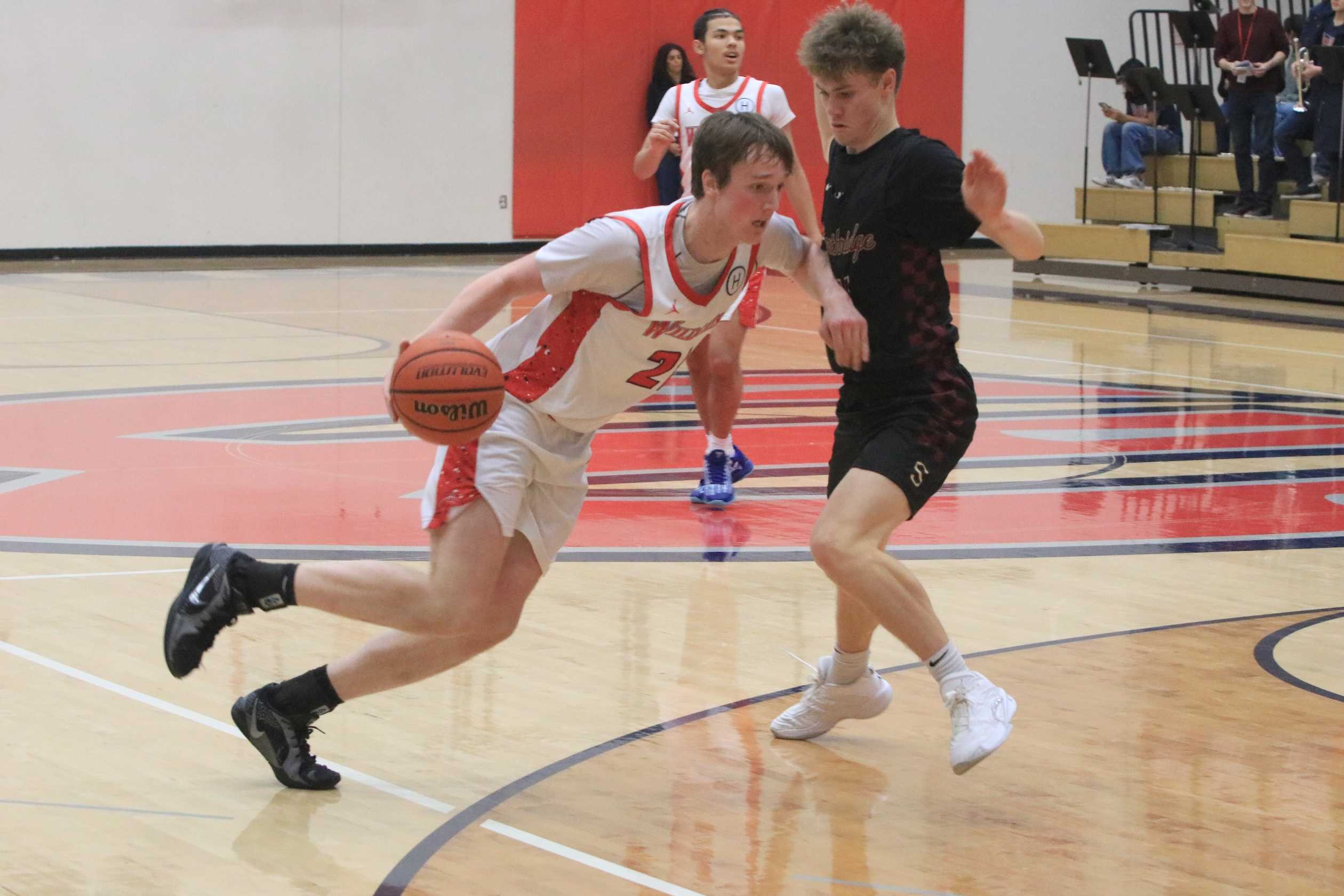 Westview's Jason Grady drives around Southridge's Julius Vesel during Friday's 70-51 Metro League win. (Photo by Jim Beseda)