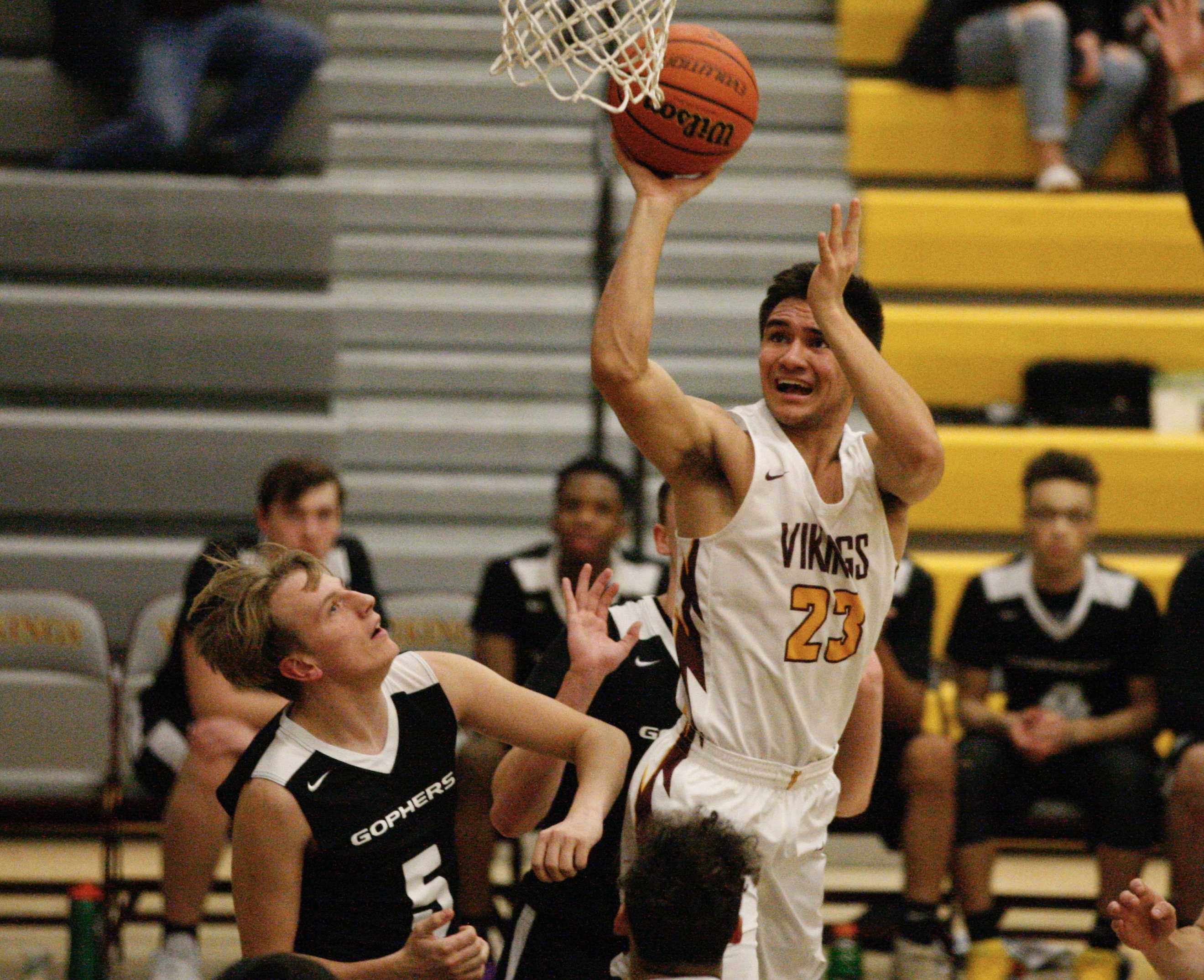 Forest Grove's Guy Littlefield drops a short shot in the key on his way to 20 points Friday. (Photo by Norm Maves Jr.)
