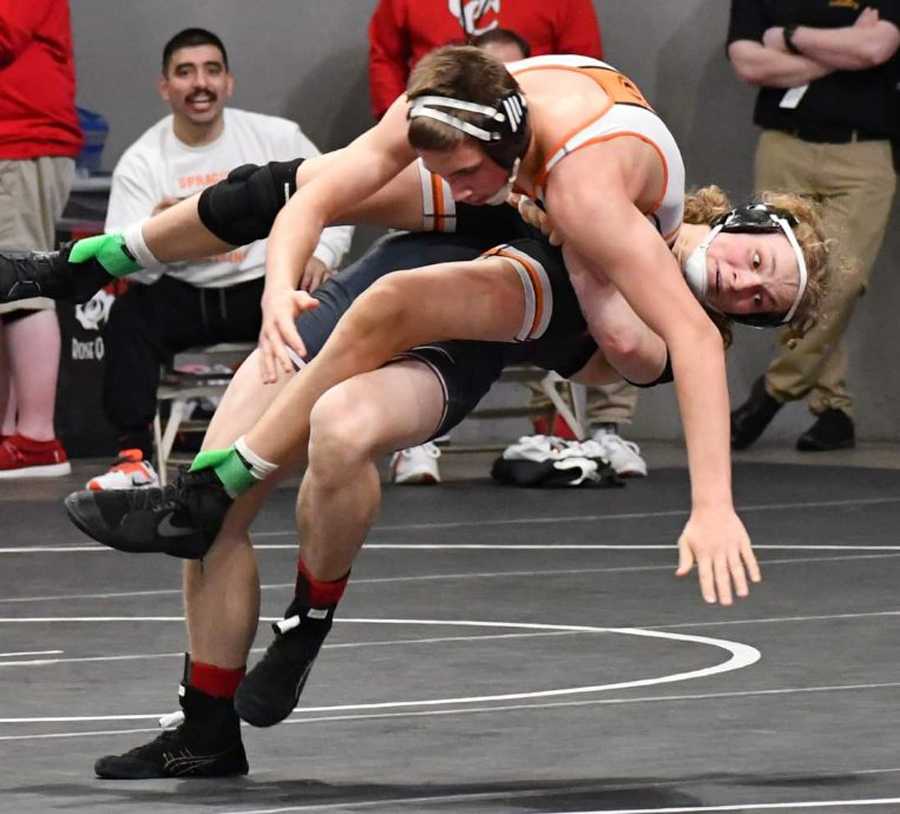 Dane Hartmann (bottom) throws an opponent on his way to 100 career wins for Franklin