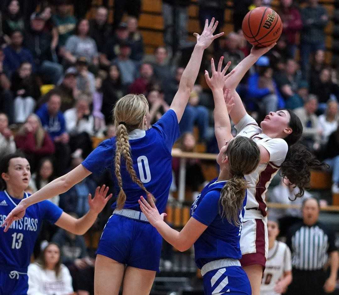 Southridge's Camryn Herzberg shoots over Grants Pass' Callie Brandes (0) in Friday's 6A playoff game. (Photo by J.R. Olson)