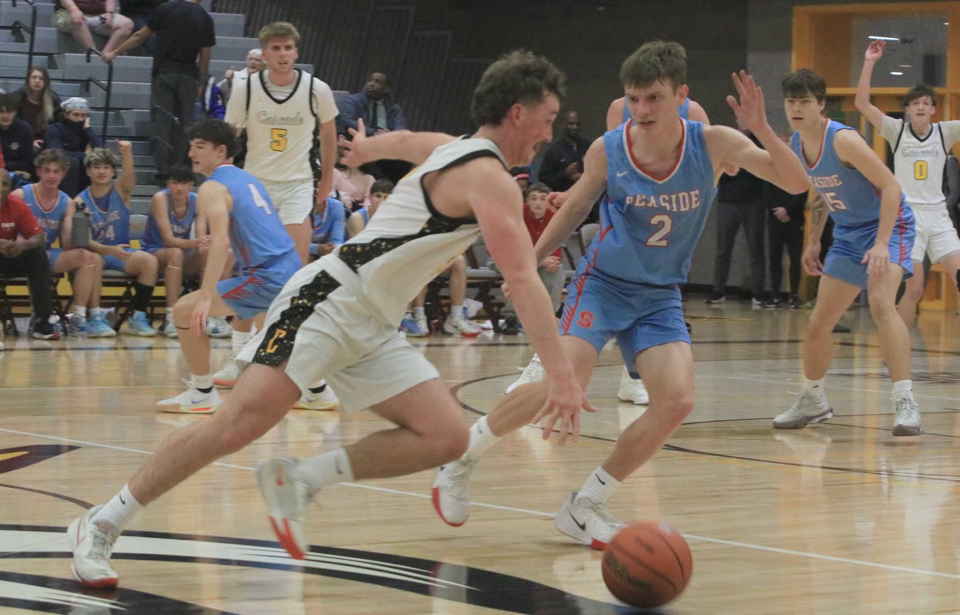 Cascade's Landon Knox pushes the ball under pressure from Seaside's Jordan Westerholm during Thursday's 4A boys quarterfinal.