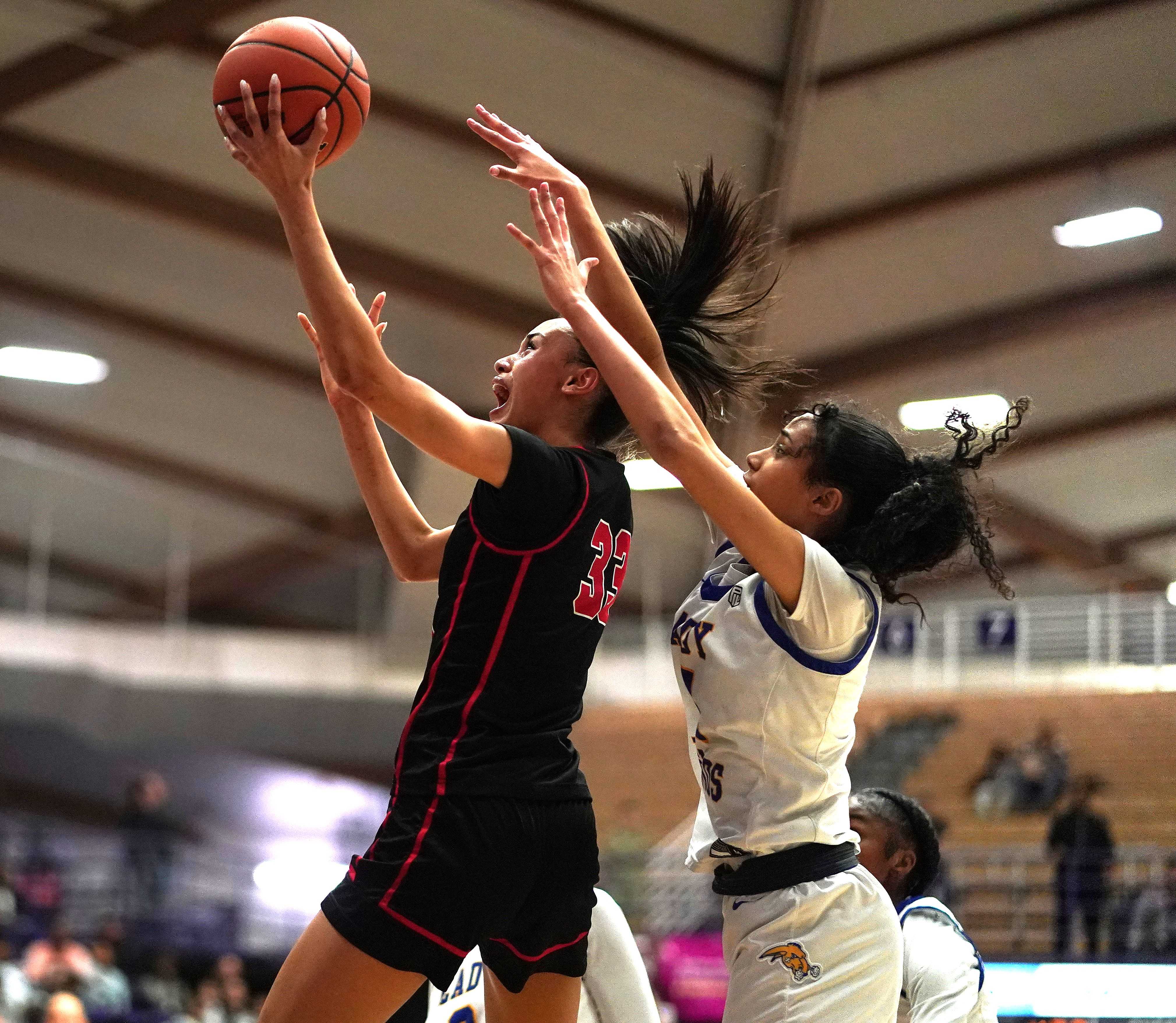 Clackamas senior Jazzy Davidson goes up for two of her 36 points in Friday's semifinal win over Jefferson. (Photo by J.R. Olson)