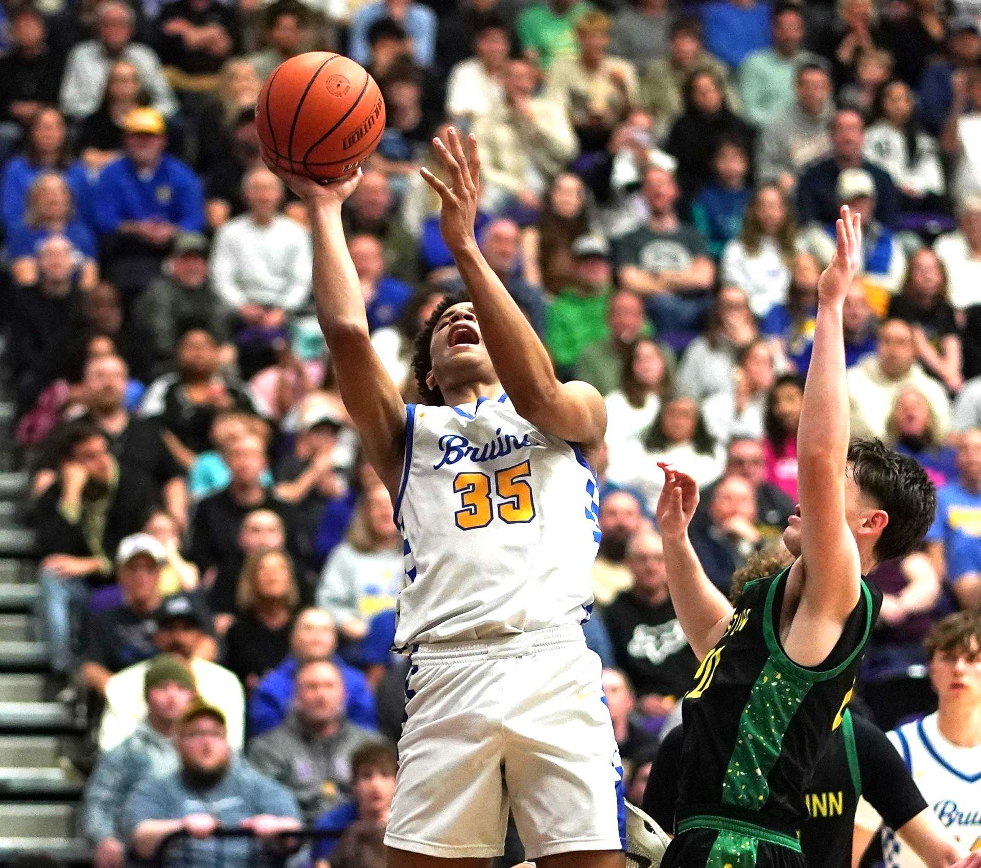 Barlow's Brayden Barron (35) goes to the basket against West Linn's Trey Price in Friday's semifinal game. (Photo by J.R. Olson)