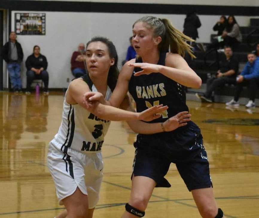 Banks' Aspen Slifka (right), guarded by North Marion's Mya Hammack, scored 18 points Tuesday. (Photo by Jeremy McDonald)