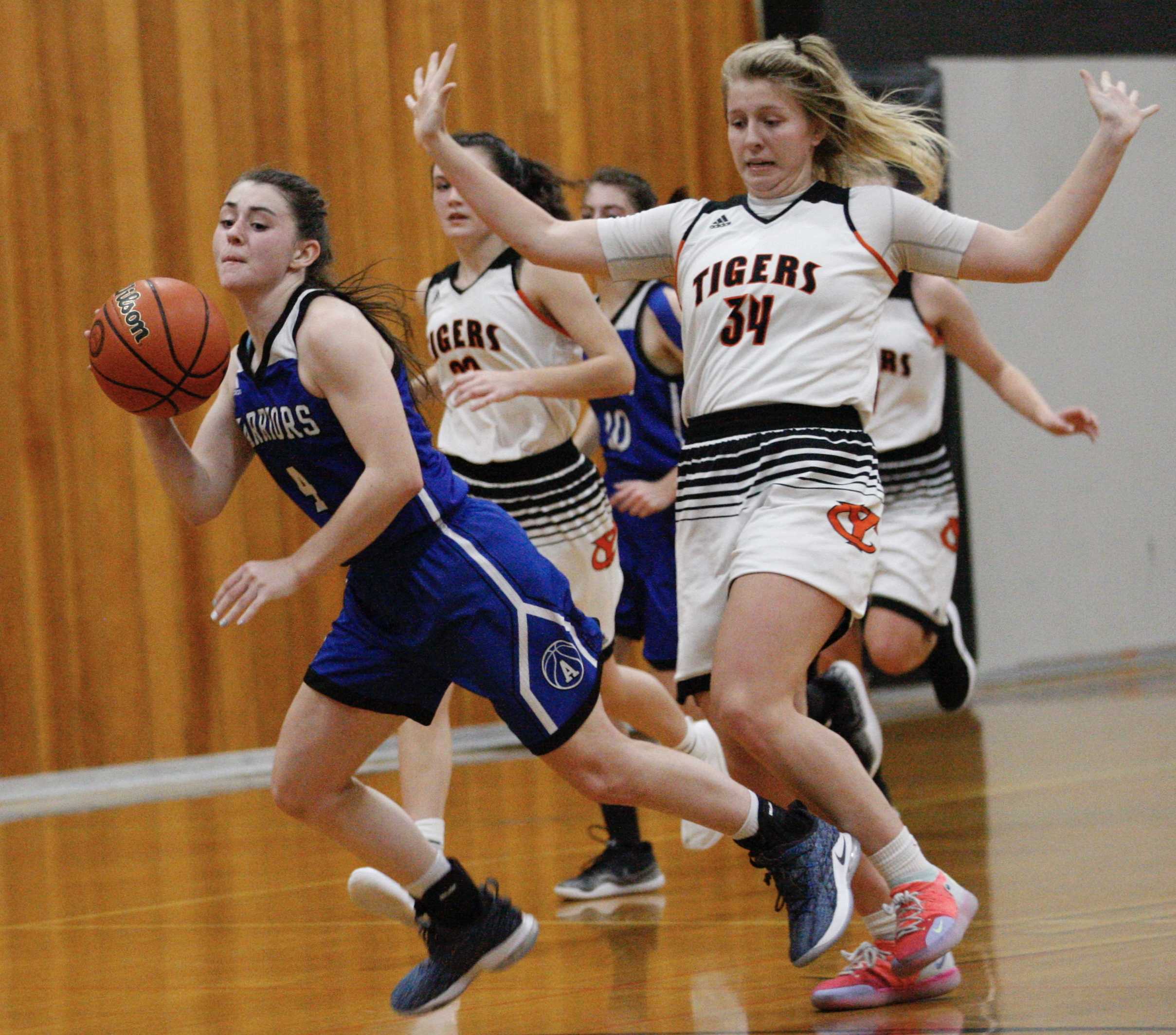 Amity's Keeley Graham (left) goes flying after getting tripped up by Yamhill-Carlton's Sadie Horne on Tuesday night.