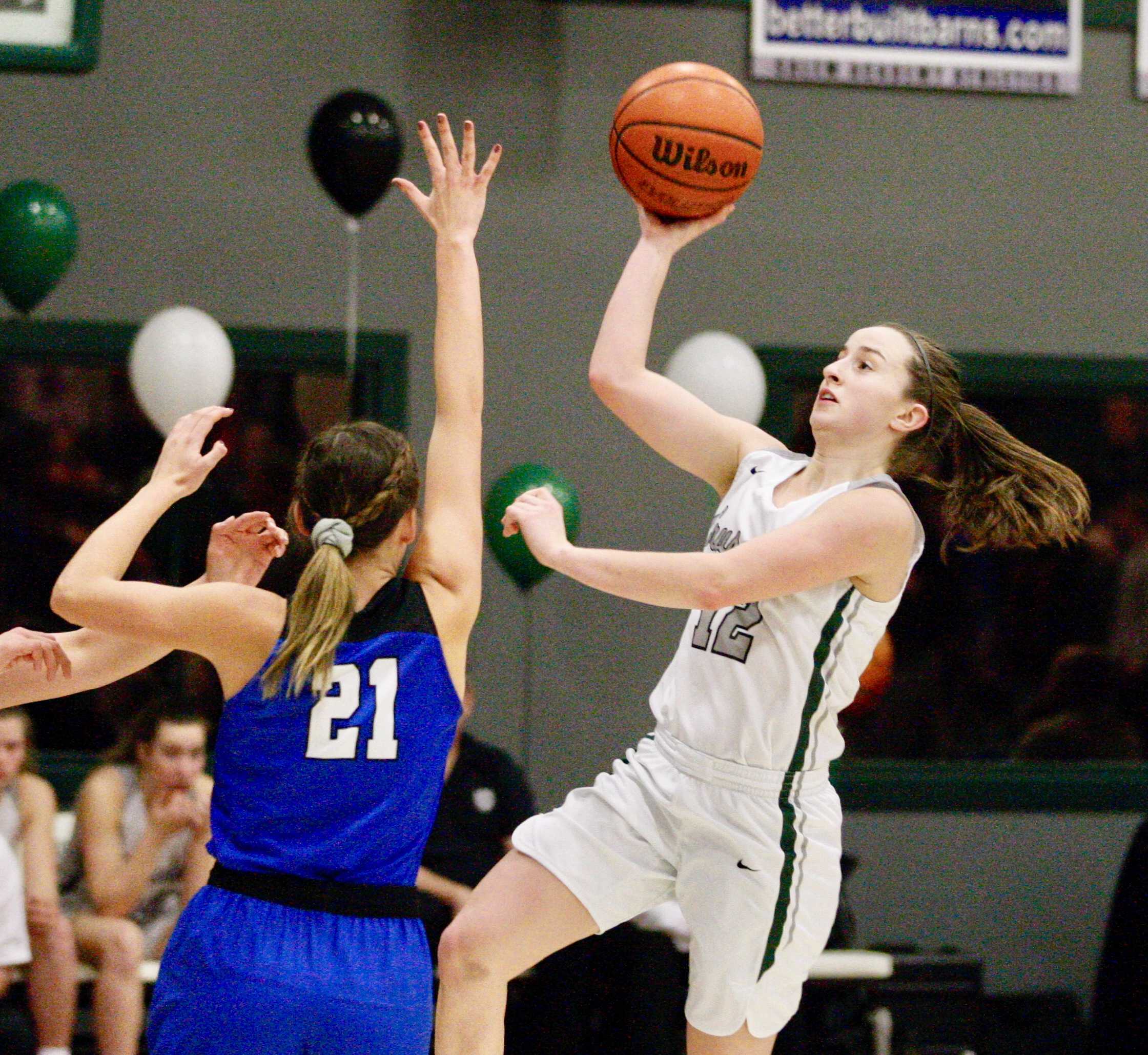 Salem Academy's Kirsten Koehnke drives past Blanchet Catholic's Hailey Ostby for two of her game-high 23 points.