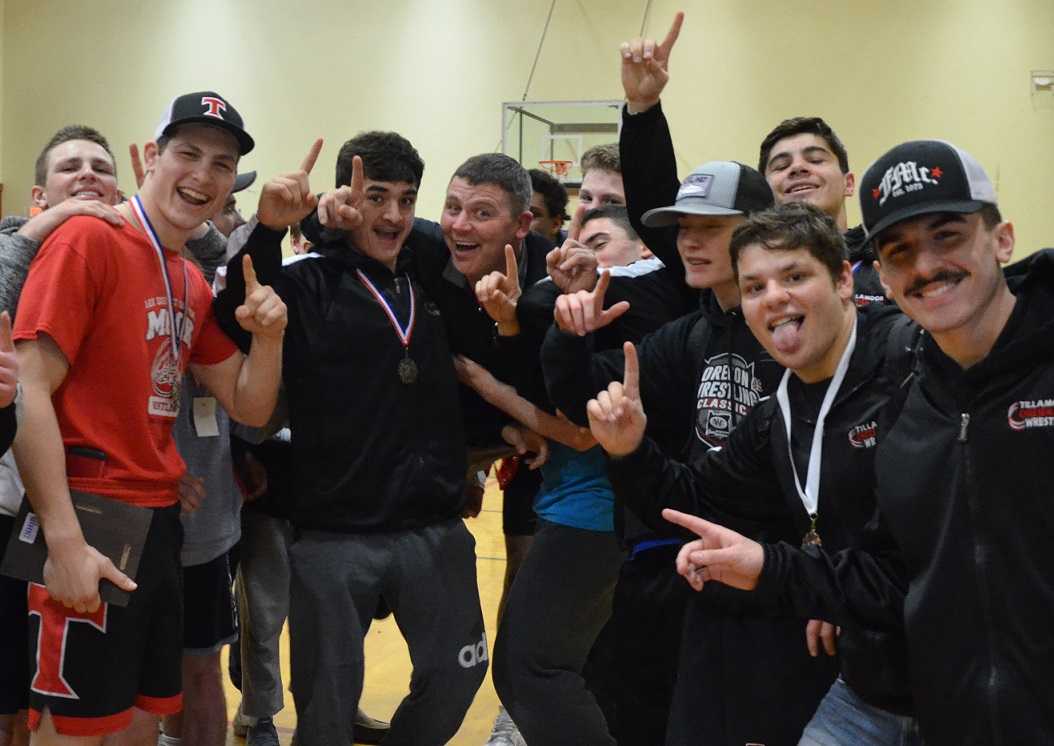 Tillamook coach Lonnie Eggert (center) and his team celebrate the Special District 1 title. (Photo by Matt Dickson)
