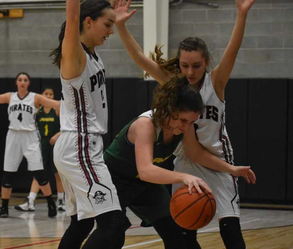 Perrydale's Amity Deters (left) and Sydney Lawrence (right) trap a Triangle Lake player Wednesday. (Photo by Jeremy McDonald)
