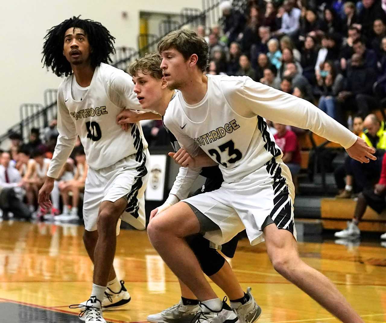 Southridge's Brock Henry (40) and Sam Finer (23) box out Mountain View's Austin Fields-Wieselman. (Photo by Jon Olson)