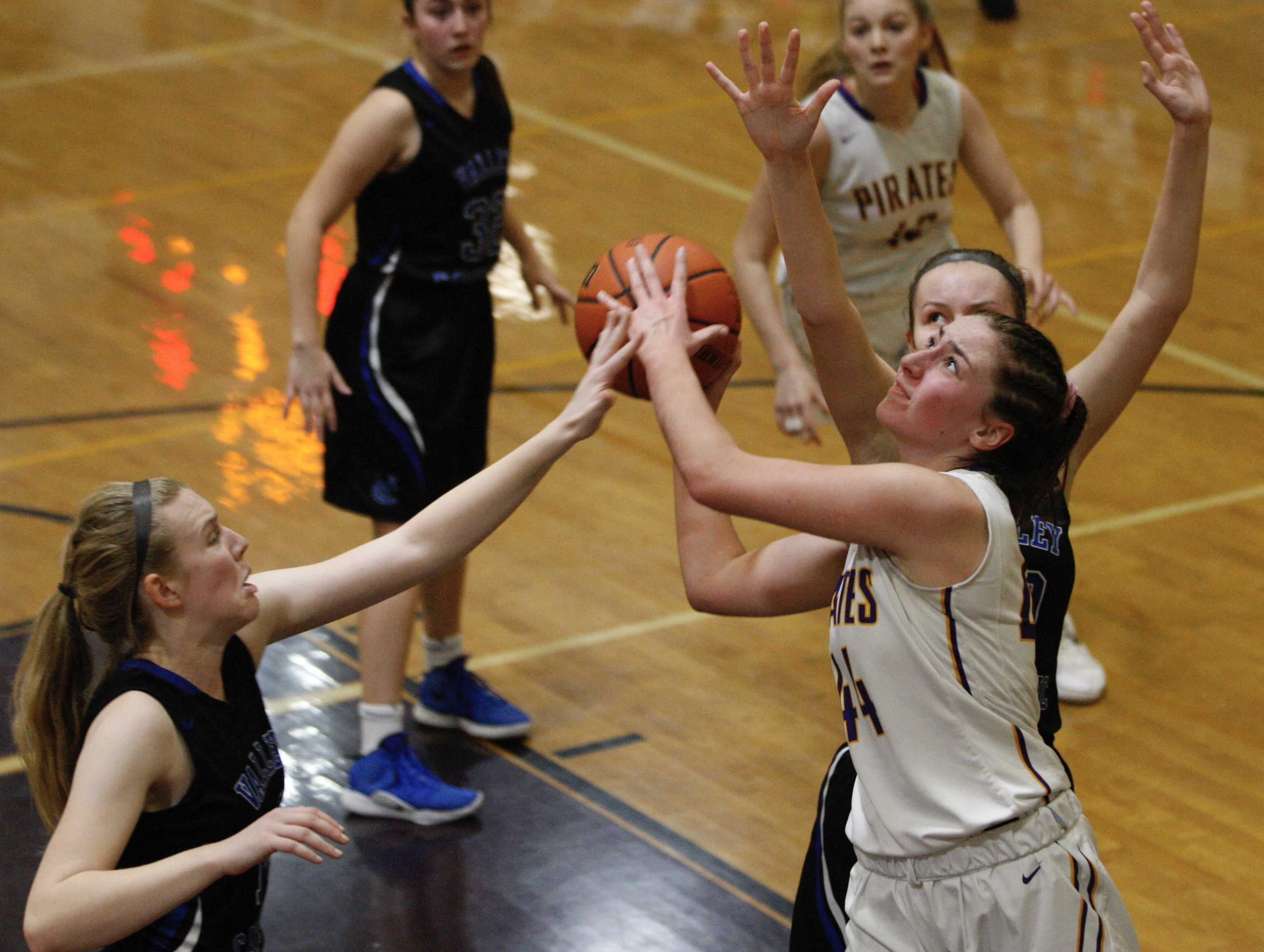 Marshfield's Alex Locati slices between two Valley Catholic defenders for two of her 12 points.
