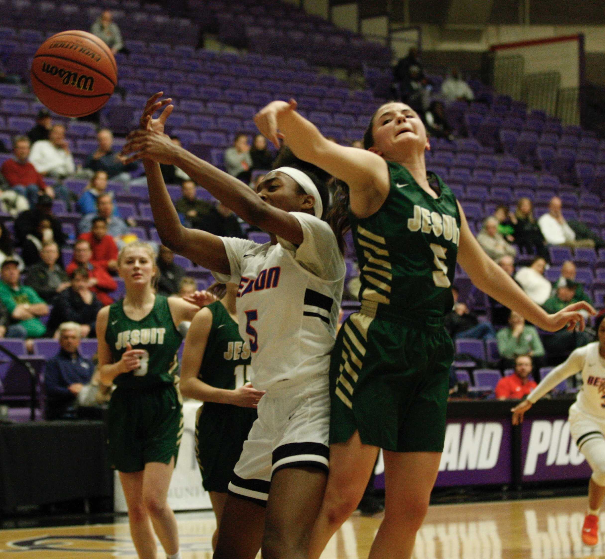 Benson's Taylor Lyday (left) and Jesuit's Anna Fanelli contest a rebound during Benson's 53-38 quarterfinal win.