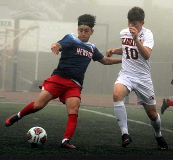 Newport's Kevin Teodoro works against Gladstone's Logan Greco (10) last season. (Photo by Robert Smith)